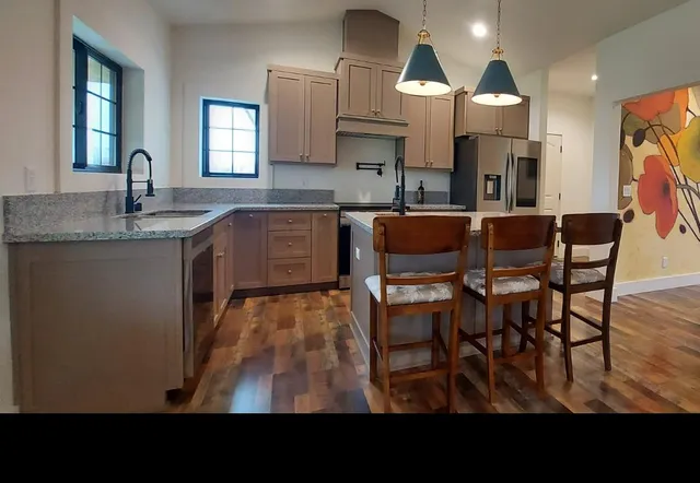 a view of a room with wooden floor and windows