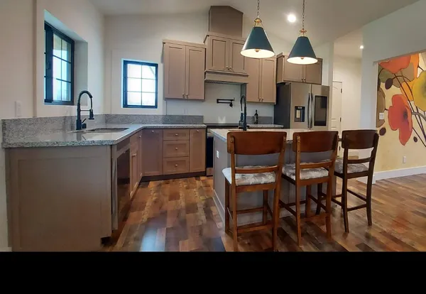 a kitchen with cabinets and wooden floor