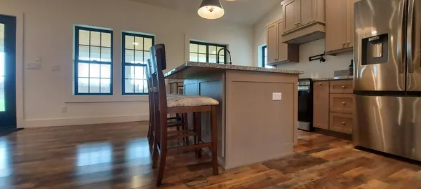 a kitchen with stainless steel appliances granite countertop a refrigerator and a sink