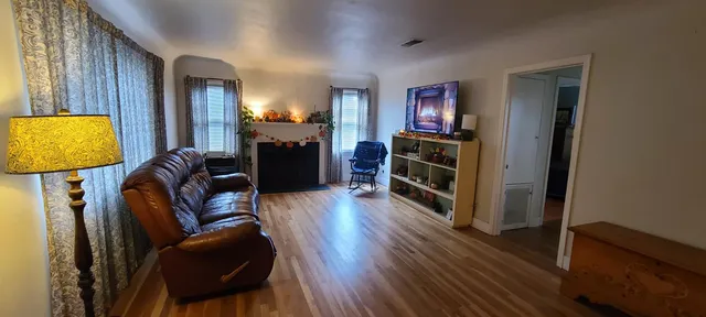 a kitchen with a refrigerator and a stove top open
