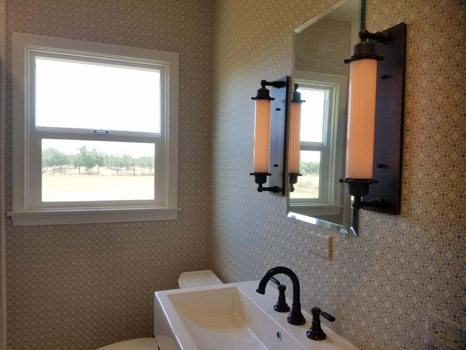1102 Barry Road Yuba City, CA 95991 - Photo 40 of 72 a bathroom with a sink a mirror and a window