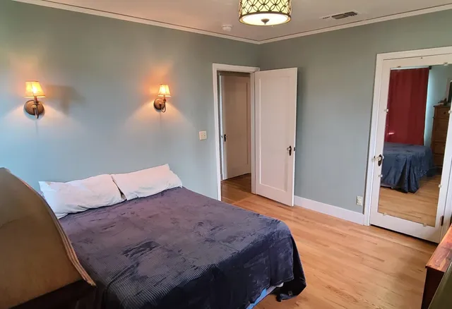 a bathroom with a toilet and a chair