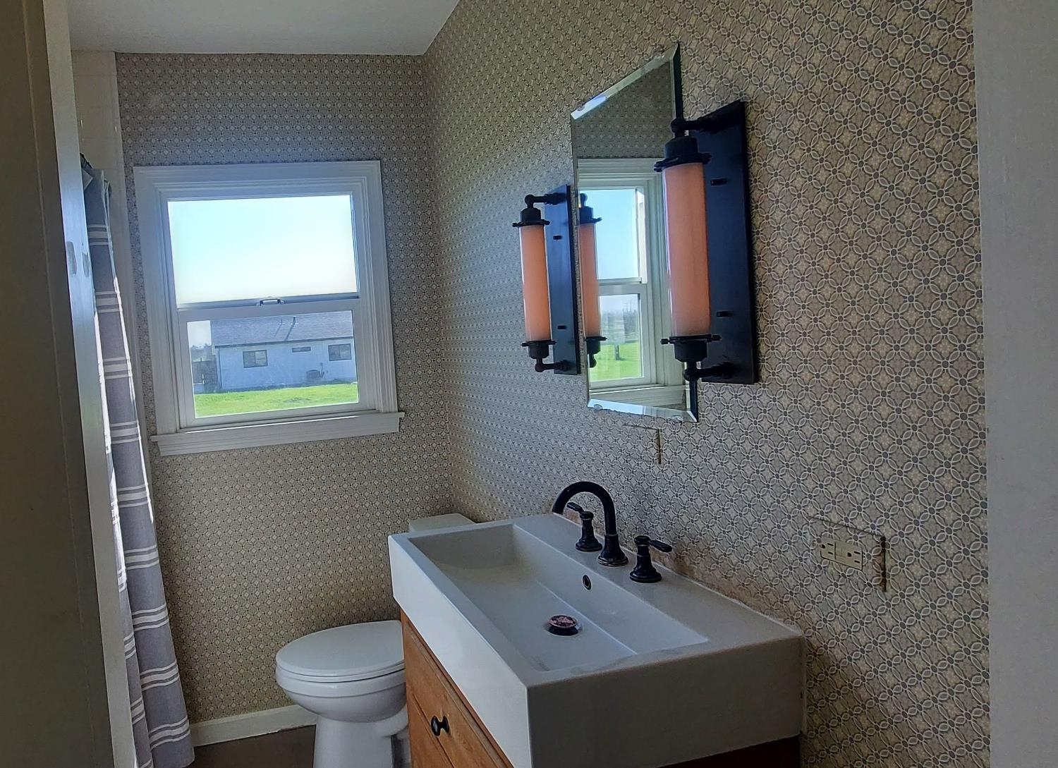 1102 Barry Road Yuba City, CA 95991 - Photo 62 of 72 a bathroom with a toilet sink and mirror