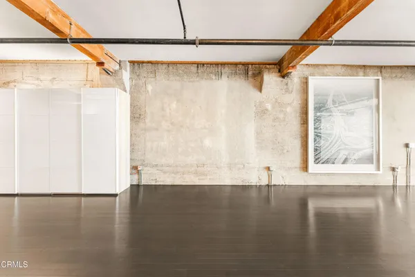 a view of a room with wooden floor and a window