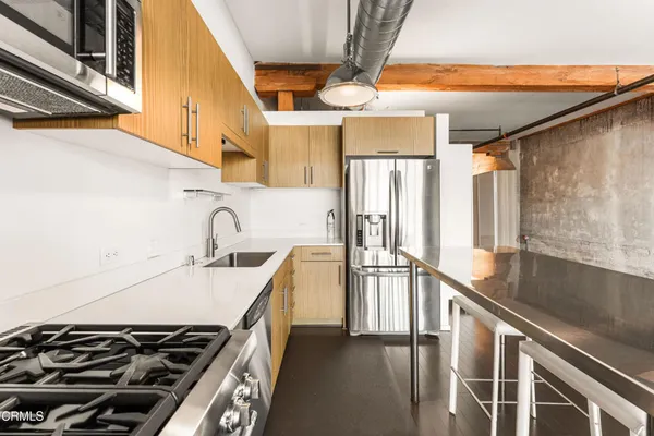 a kitchen with a sink and a stove top oven