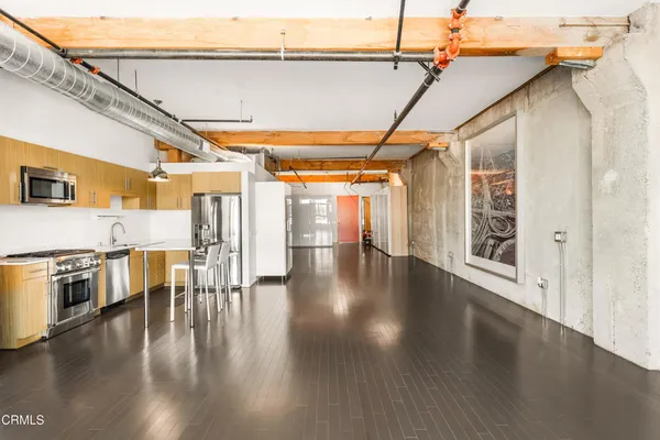 a view of a kitchen with a dishwasher and wooden floor