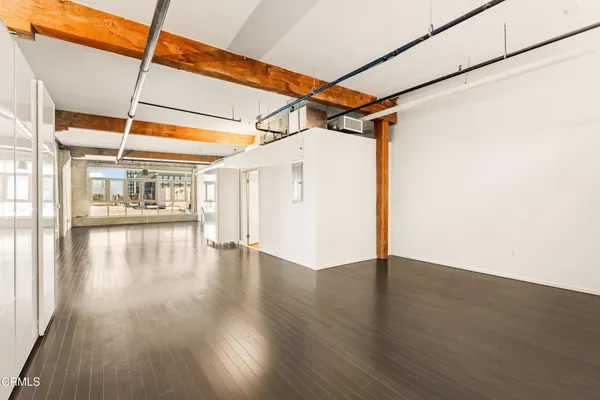 a view of a room with wooden floor