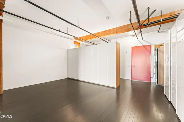 a view of a room with wooden floor and windows