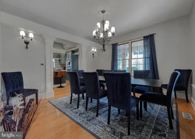 a living room with furniture a fireplace and a large window