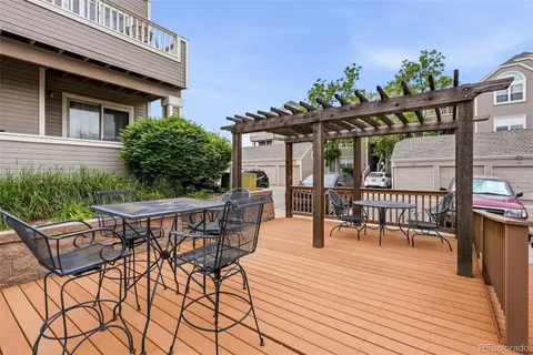 a roof deck with table and chairs