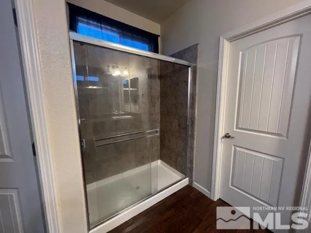 a bathroom with a glass shower door