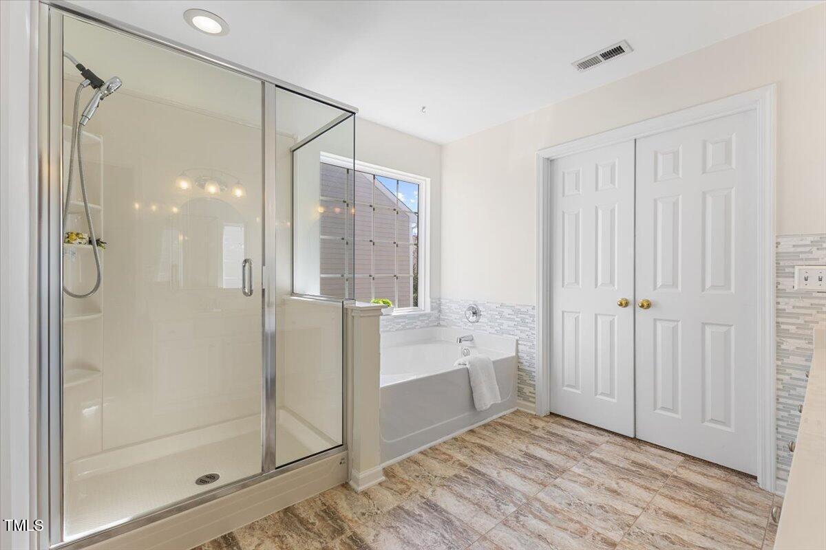 5415 Regatta Way Raleigh, NC 27613 - Photo 29 of 40 a spacious bathroom with a shower and a glass door