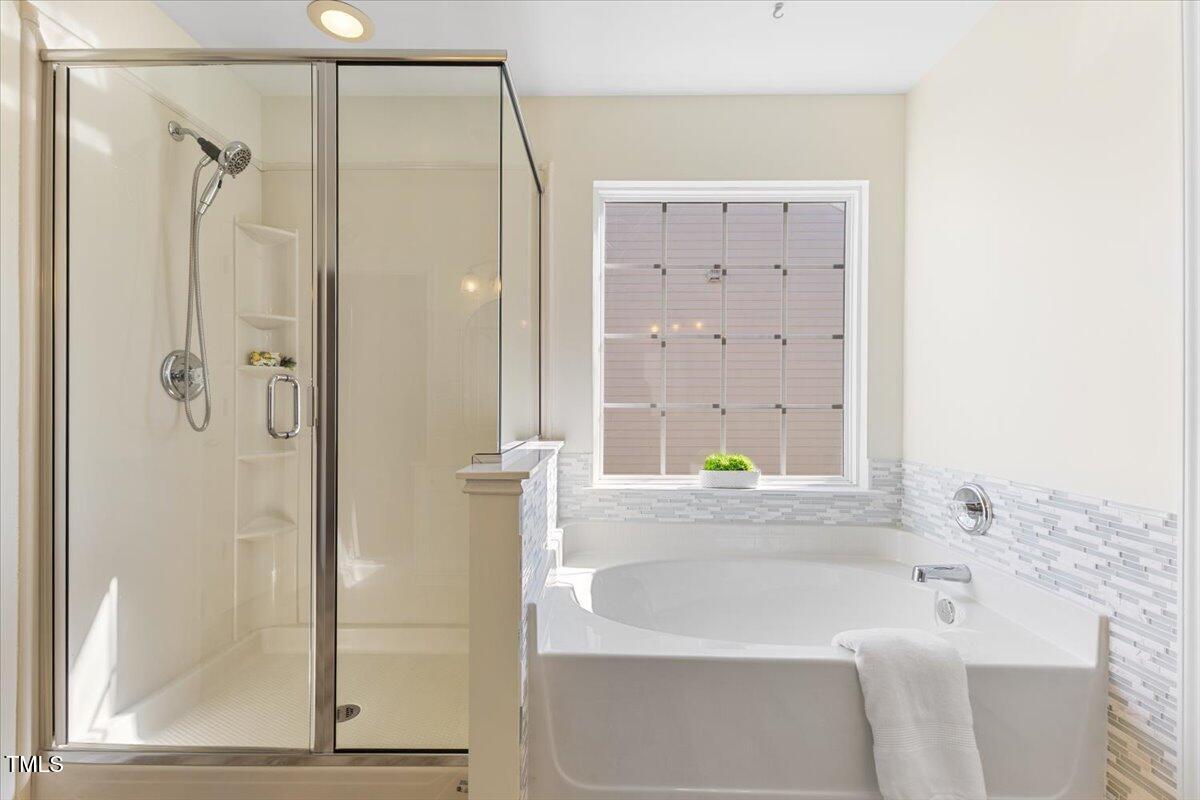 5415 Regatta Way Raleigh, NC 27613 - Photo 30 of 40 a bathroom with a bathtub and a shower