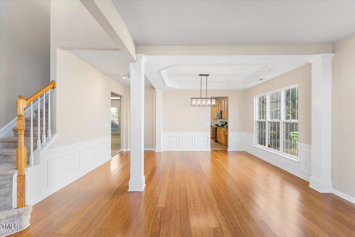 5415 Regatta Way Raleigh, NC 27613 - Photo 5 of 40 a view of an empty room with wooden floor and a window