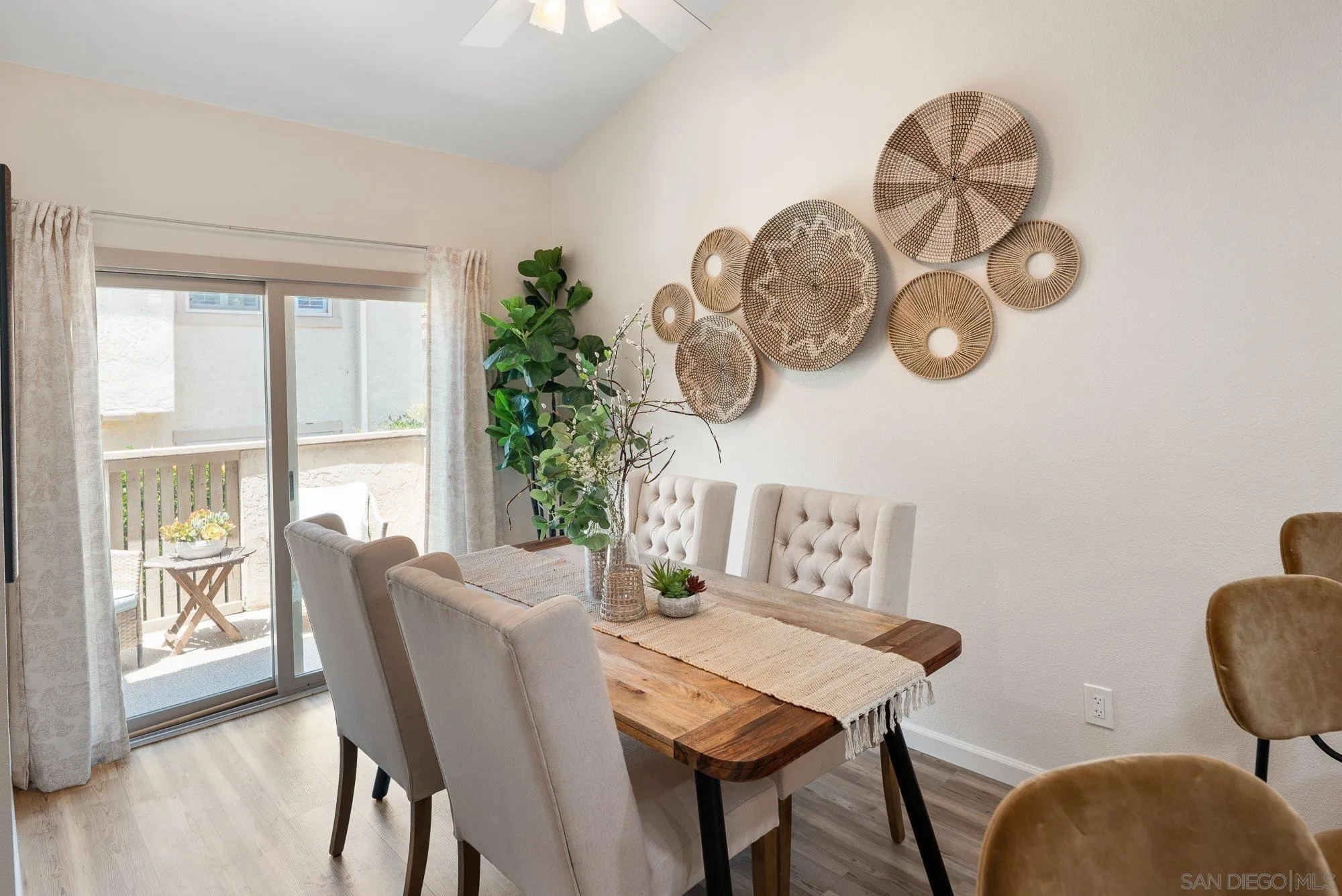 2352 Altisma Way, Unit 15 Carlsbad, CA 92009 - Photo 17 of 42 a view of a dining room with furniture window and wooden floor