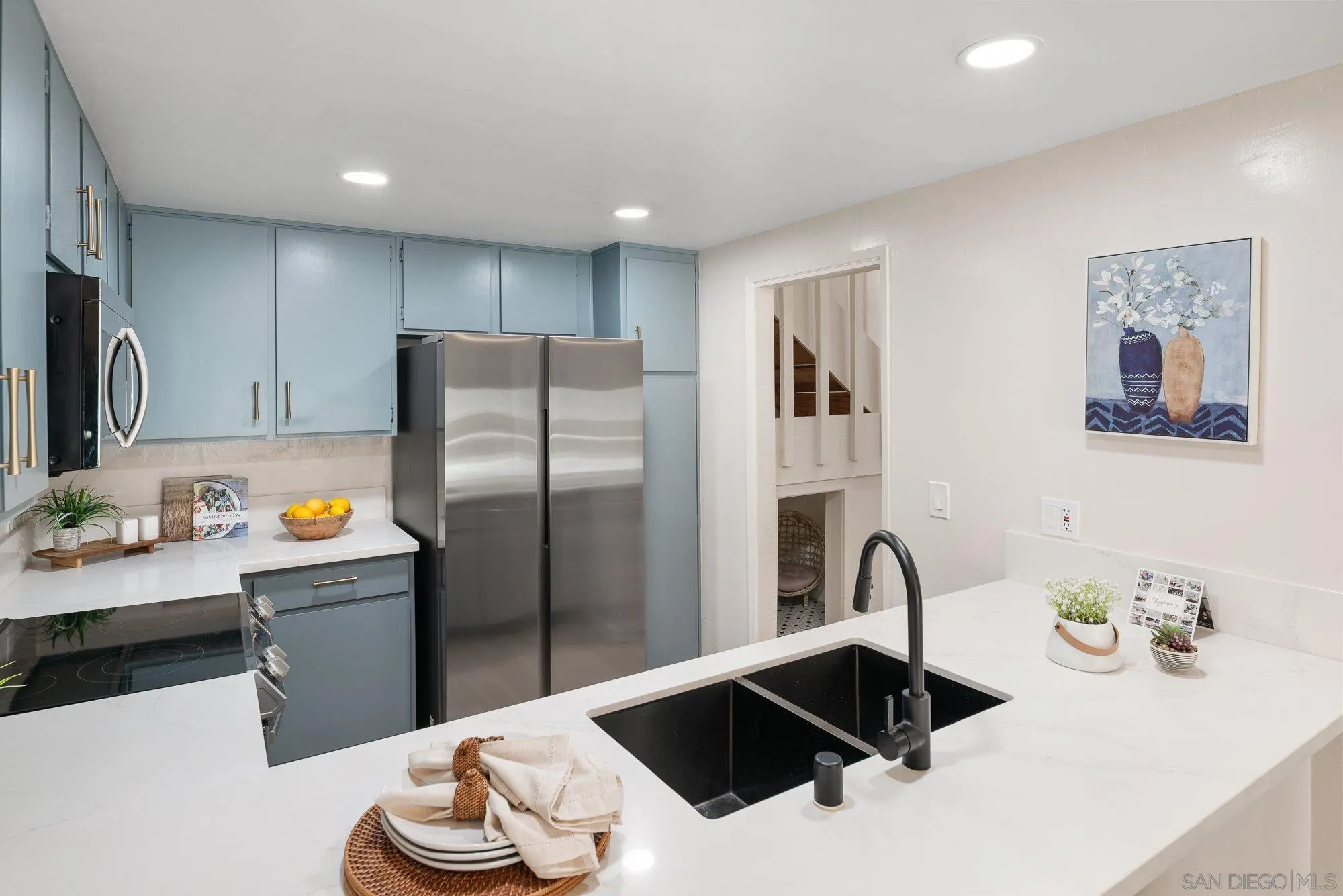 2352 Altisma Way, Unit 15 Carlsbad, CA 92009 - Photo 22 of 42 a kitchen with a refrigerator and a sink