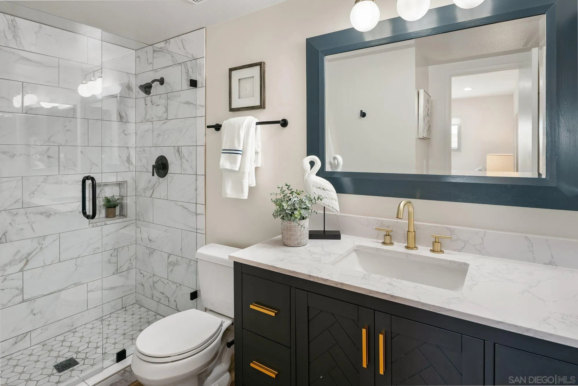 2352 Altisma Way, Unit 15 Carlsbad, CA 92009 - Photo 28 of 42 a bathroom with a sink a toilet and shower
