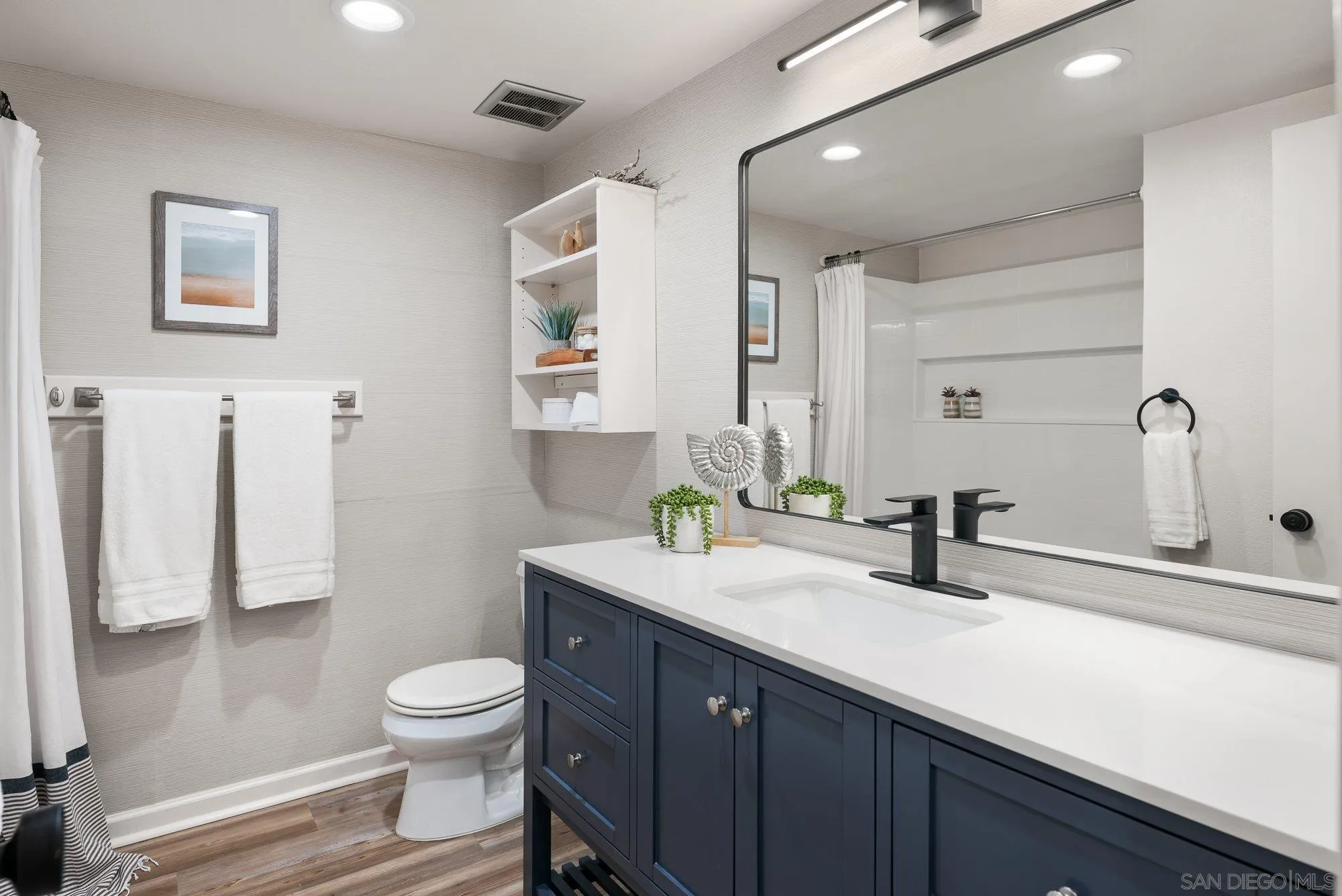2352 Altisma Way, Unit 15 Carlsbad, CA 92009 - Photo 32 of 42 a bathroom with a sink a toilet and shower