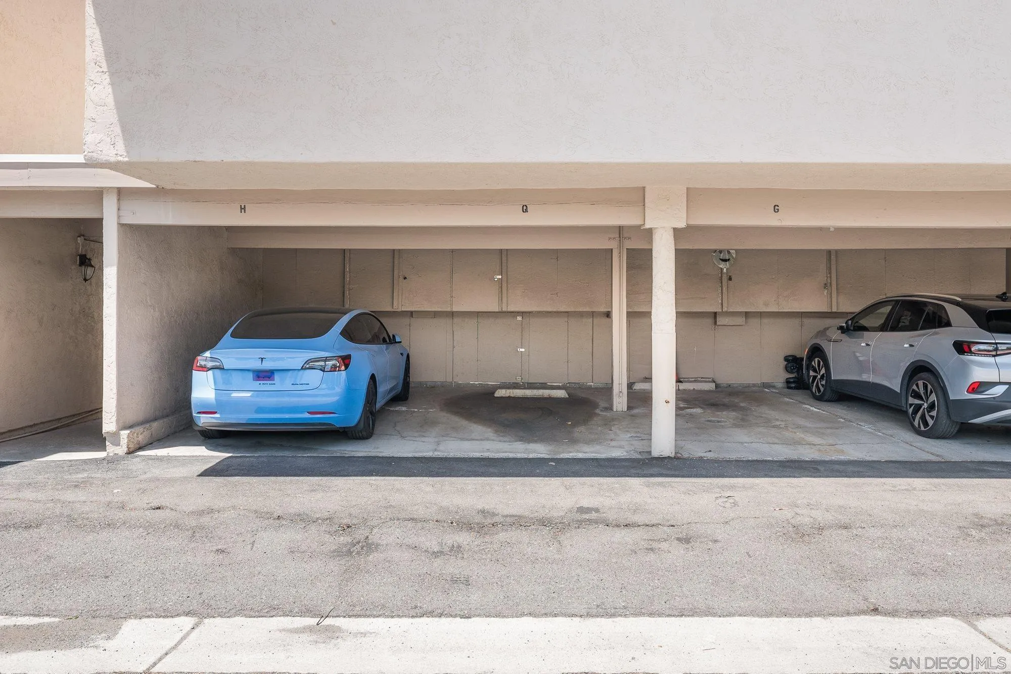 2352 Altisma Way, Unit 15 Carlsbad, CA 92009 - Photo 37 of 42 a car parked on the side of the road