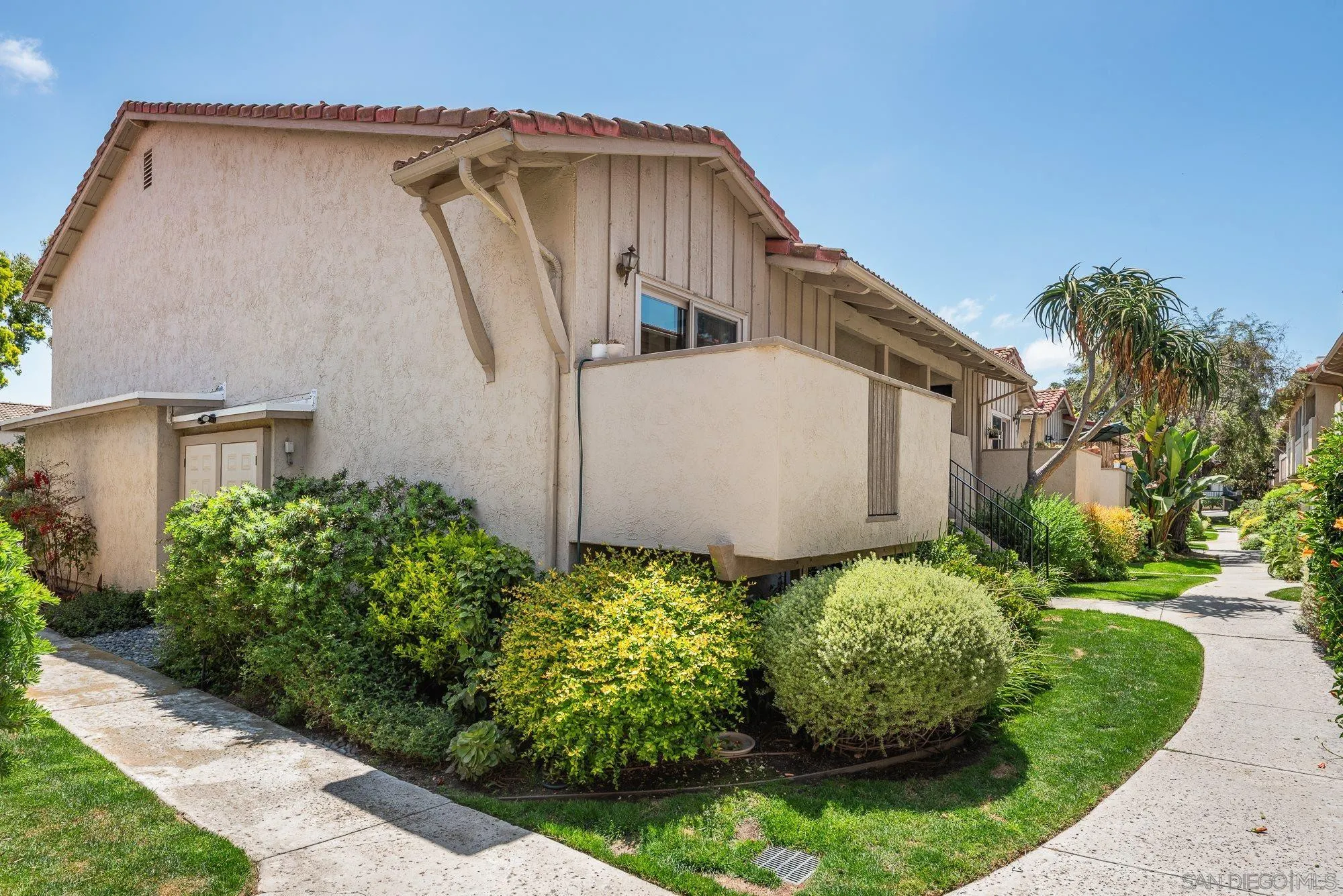 2352 Altisma Way, Unit 15 Carlsbad, CA 92009 - Photo 8 of 42 a front view of a house with garden