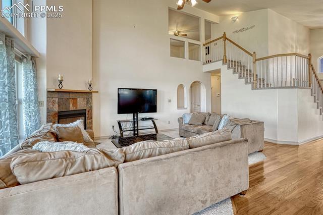 11455 Dallas Road Peyton, CO 80831 - Photo 11 of 50 Family Room with soaring ceiling, lighted ceiling fan, and view of stairs to the upper level.