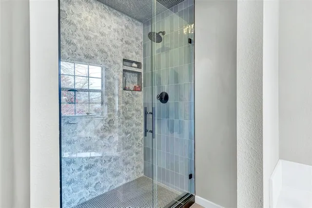a bathroom with a glass shower door