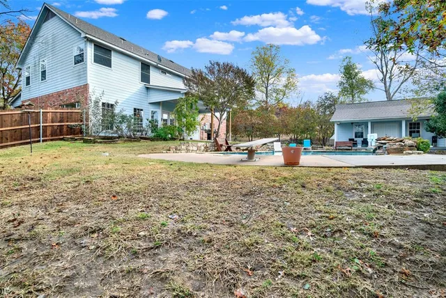 a view of a house with backyard and sitting area