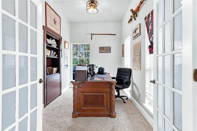a view of a workspace with furniture and a window