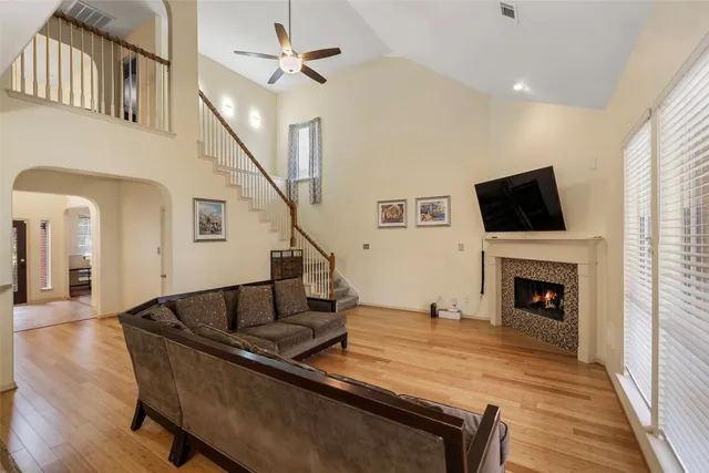 a living room with fireplace furniture and a flat screen tv