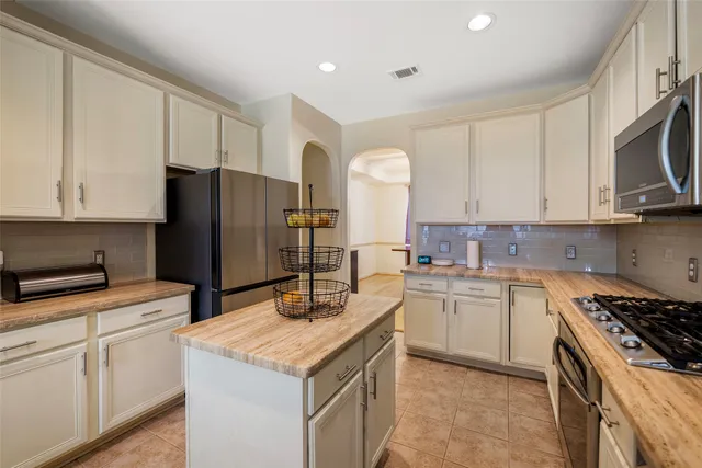 a kitchen with a sink stove and refrigerator