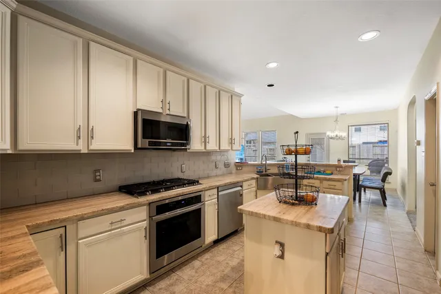 a kitchen with a sink a stove and cabinets