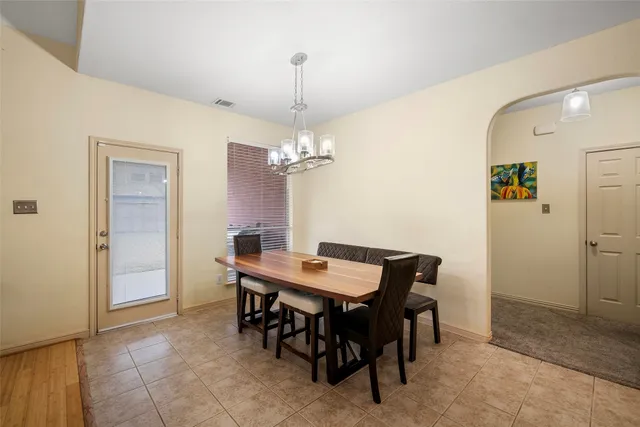 a view of a dining room with furniture and a chandelier