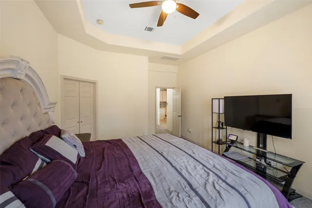 a bedroom with a bed and a flat screen tv