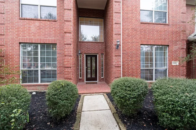 a view of brick house with a large windows