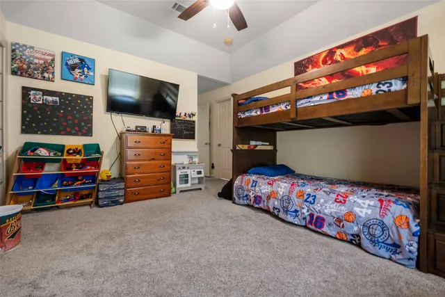 a bedroom with furniture and flat screen tv