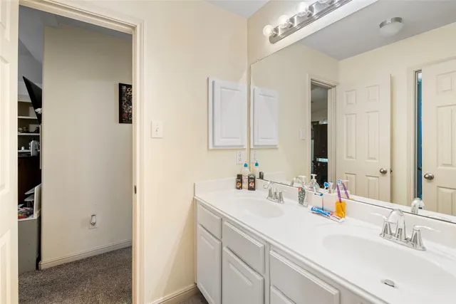 a bathroom with 2 sink and a mirror