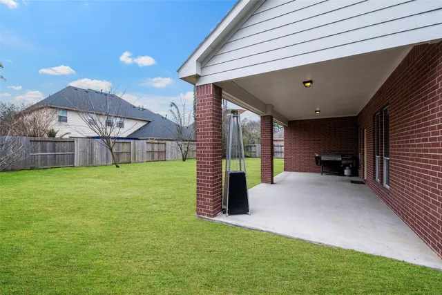 a view of a house with a backyard and a tub