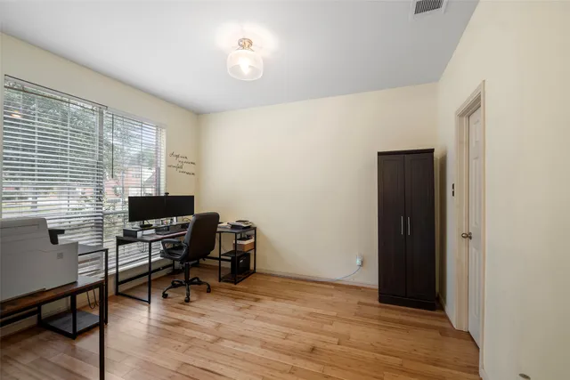 a view of a workspace with furniture and a window