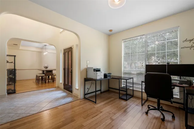 a livingroom with workspace and a window