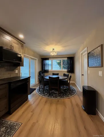 a kitchen with kitchen island granite countertop a stove and a wooden floors