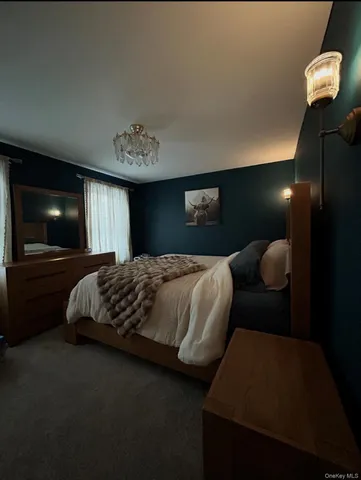 a bedroom with a bed and a television