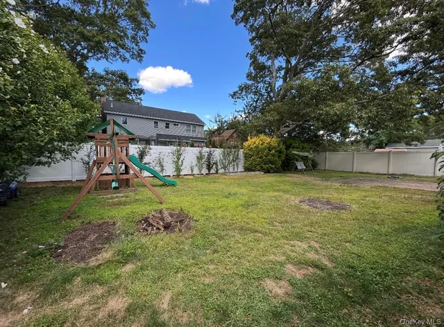 a view of a backyard with a garden and entertaining space
