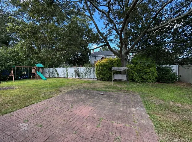 a view of a backyard with large trees