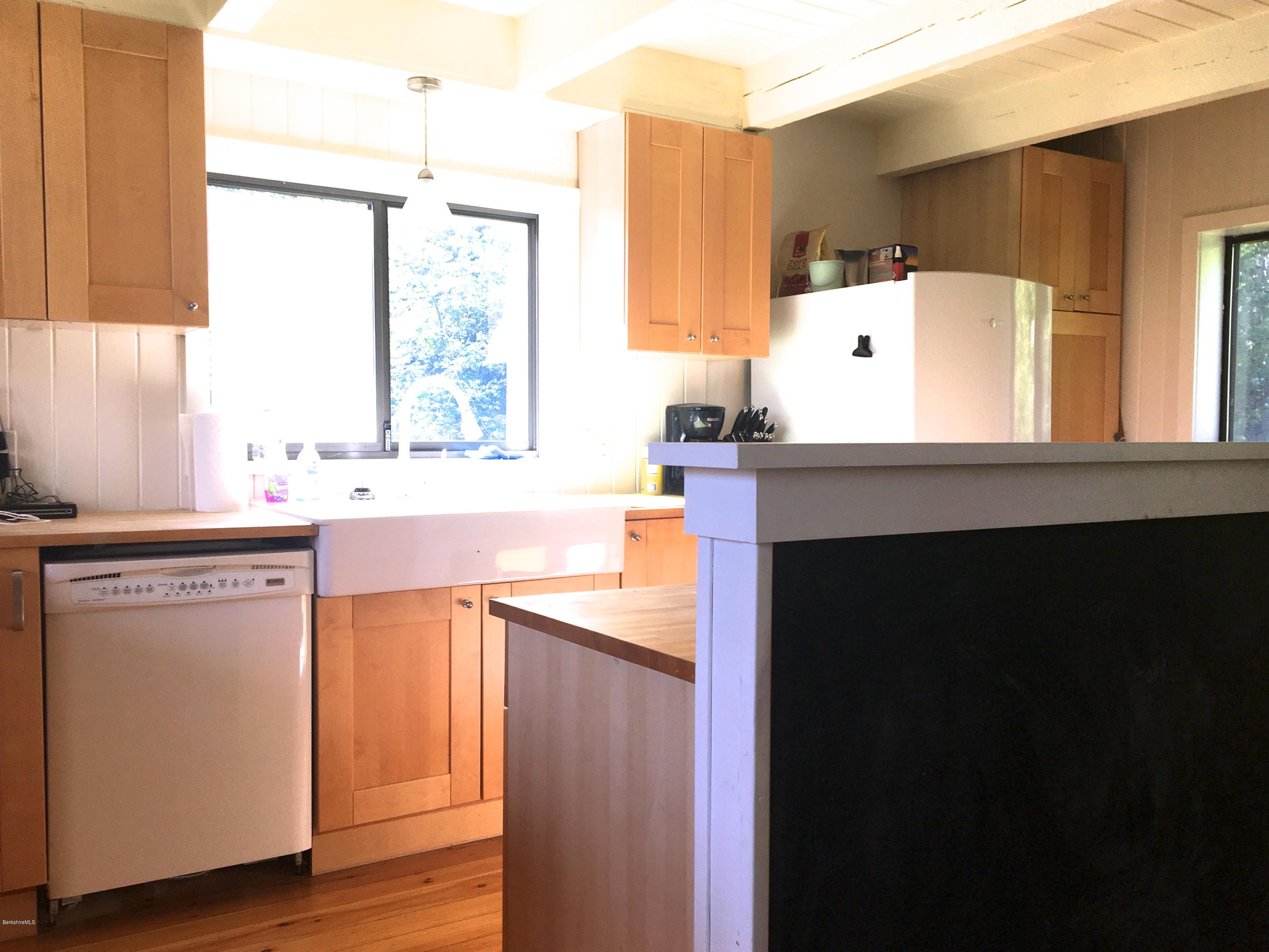 10 Stump Road Sandisfield, MA 01255 - Photo 22 of 30 a kitchen with a sink dishwasher a stove and a refrigerator with wooden floor