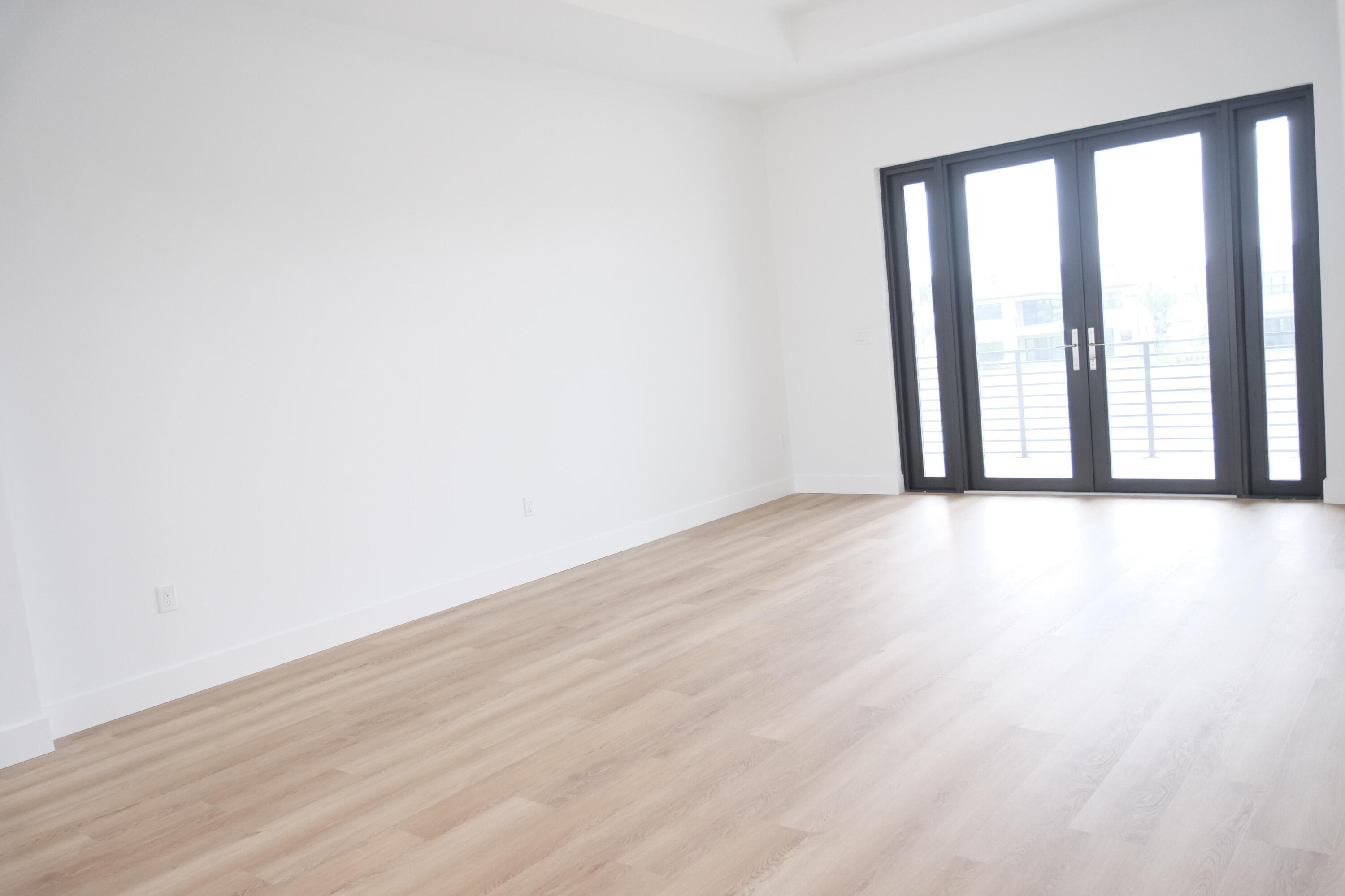 9516 Riverside Pk Drive Boca Raton, FL 33434 - Photo 17 of 24 a view of an empty room with wooden floor and a window