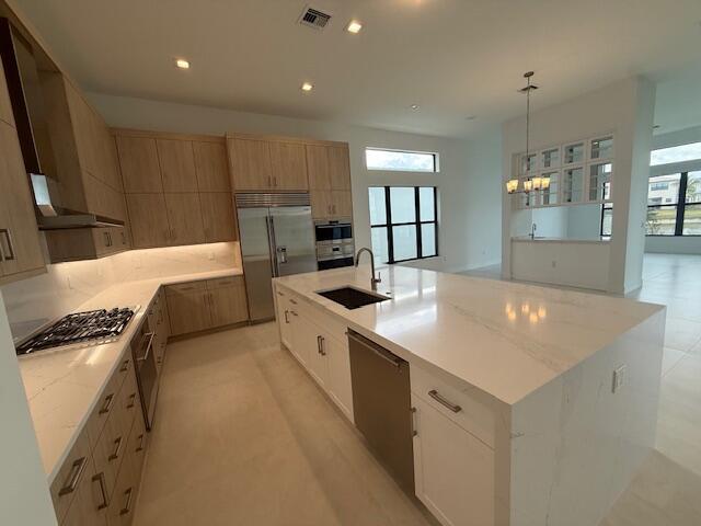 9516 Riverside Pk Drive Boca Raton, FL 33434 - Photo 4 of 24 a large kitchen with kitchen island a sink stainless steel appliances and cabinets