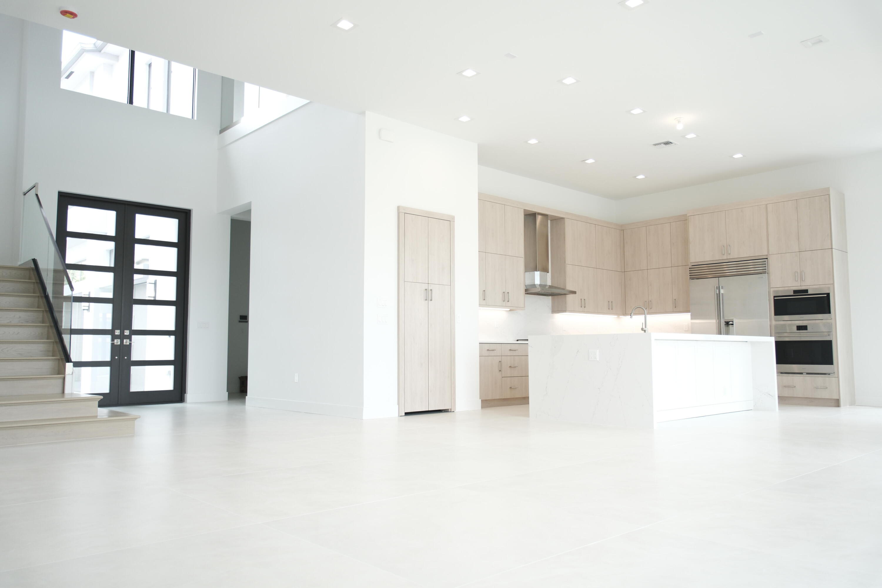 9516 Riverside Pk Drive Boca Raton, FL 33434 - Photo 6 of 24 a living room with stainless steel appliances kitchen island furniture and a kitchen view