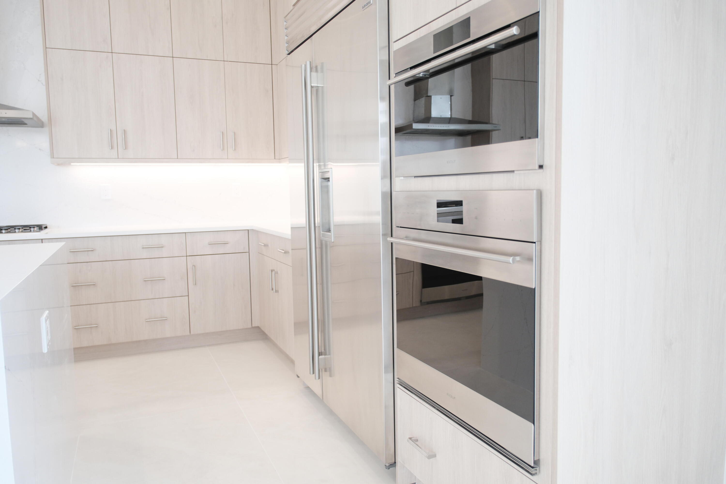 9516 Riverside Pk Drive Boca Raton, FL 33434 - Photo 10 of 24 a kitchen with white cabinets and a refrigerator