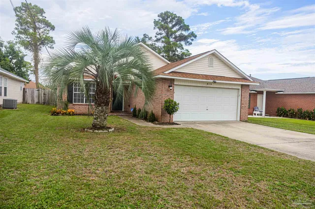 a front view of house with yard and green space
