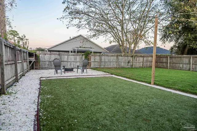a front view of a house with patio and garden